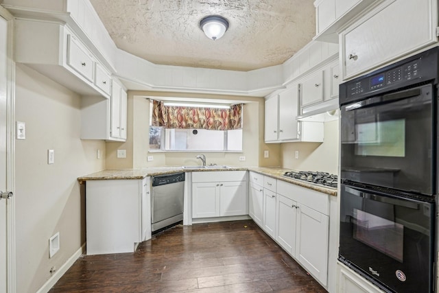 kitchen featuring dark wood-type flooring, sink, white cabinetry, a textured ceiling, and stainless steel appliances