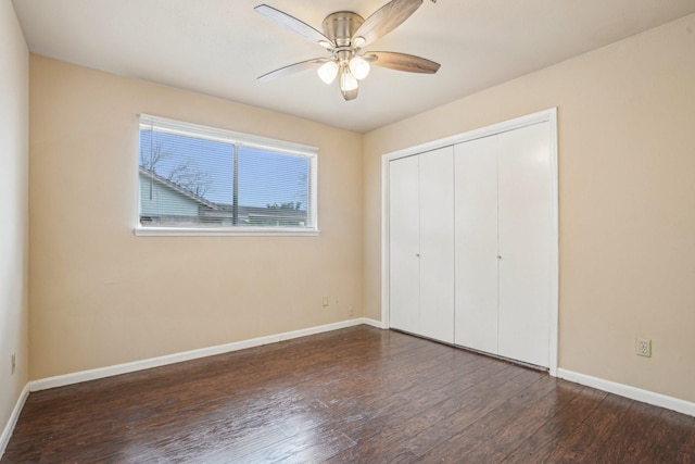 unfurnished bedroom featuring ceiling fan, dark hardwood / wood-style flooring, and a closet