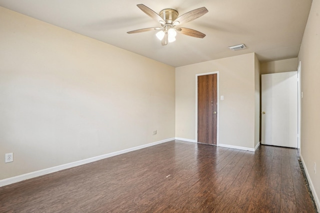 unfurnished room featuring dark wood-type flooring and ceiling fan