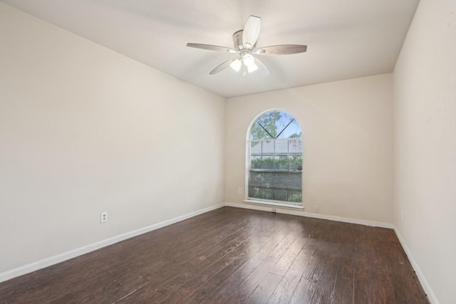 empty room with dark wood-type flooring and ceiling fan