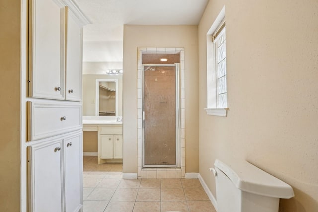 bathroom featuring tile patterned flooring and a shower with shower door