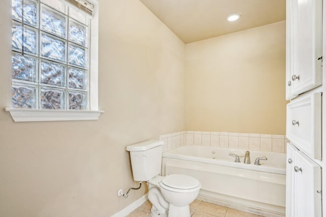 bathroom with toilet, a bathing tub, and tile patterned flooring