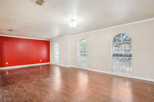 spare room featuring ornamental molding and hardwood / wood-style floors