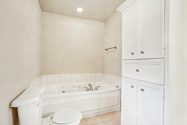 bathroom featuring a bath, tile patterned floors, and toilet