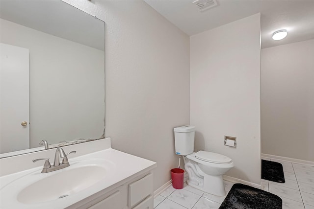 bathroom with vanity and toilet