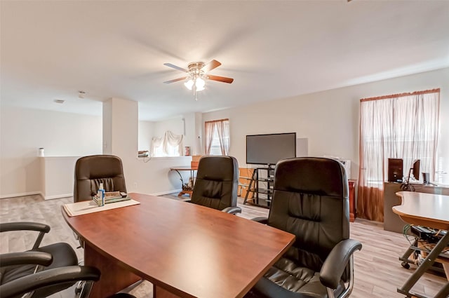 office space with ceiling fan, a healthy amount of sunlight, and light wood-type flooring