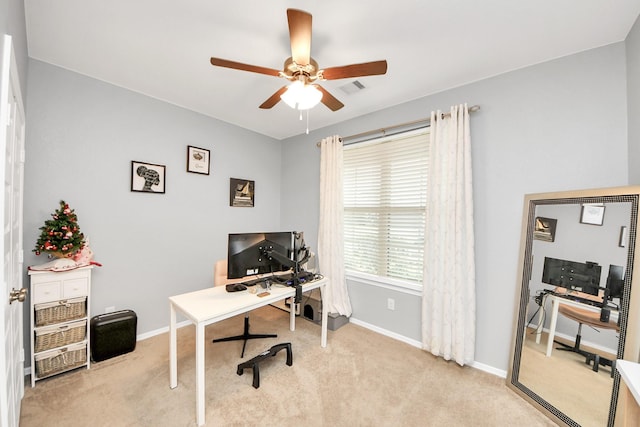 carpeted office space with ceiling fan