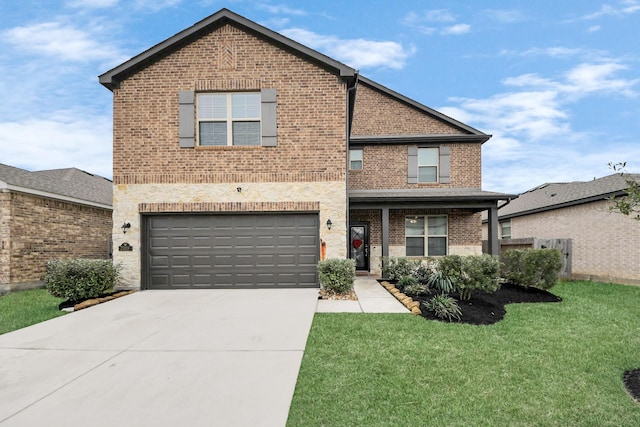 view of property featuring a garage and a front lawn