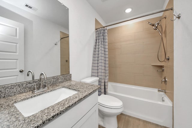 full bathroom featuring vanity, wood-type flooring, shower / bathtub combination with curtain, and toilet