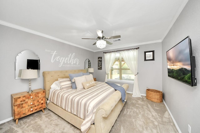 carpeted bedroom with ceiling fan and ornamental molding