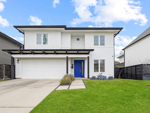 view of front of property featuring a garage, concrete driveway, and a front yard