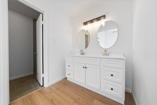 bathroom with hardwood / wood-style flooring and vanity