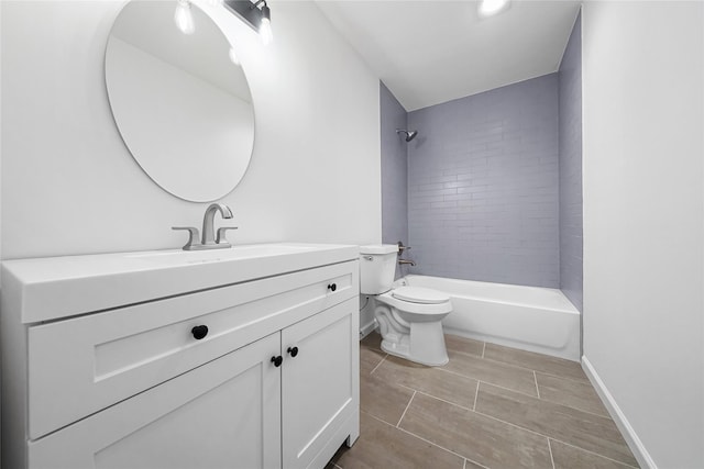 full bathroom with tiled shower / bath, vanity, and toilet