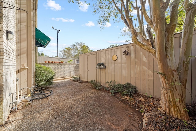 view of patio with a storage shed