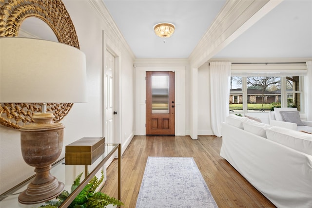 foyer featuring ornamental molding and light hardwood / wood-style floors