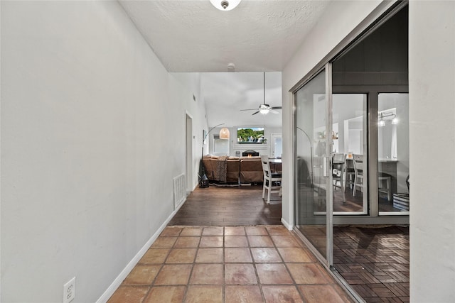 corridor featuring a textured ceiling