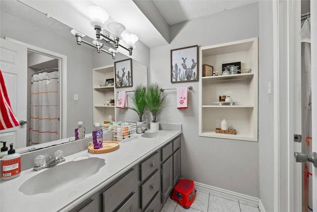 bathroom with vanity, a notable chandelier, built in features, and tile patterned floors