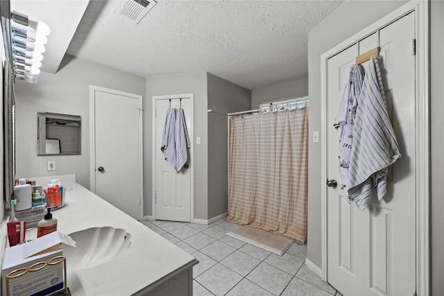 bathroom with vanity, tile patterned floors, a textured ceiling, and a shower with shower curtain