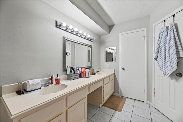 bathroom with vanity, tile patterned flooring, and a textured ceiling