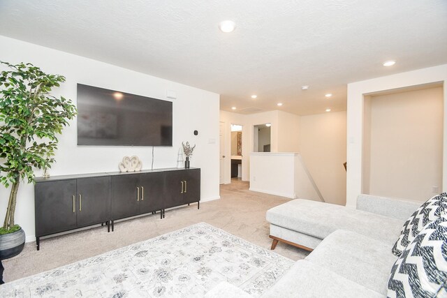 carpeted living room with a textured ceiling