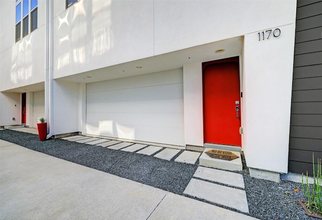 doorway to property with a garage