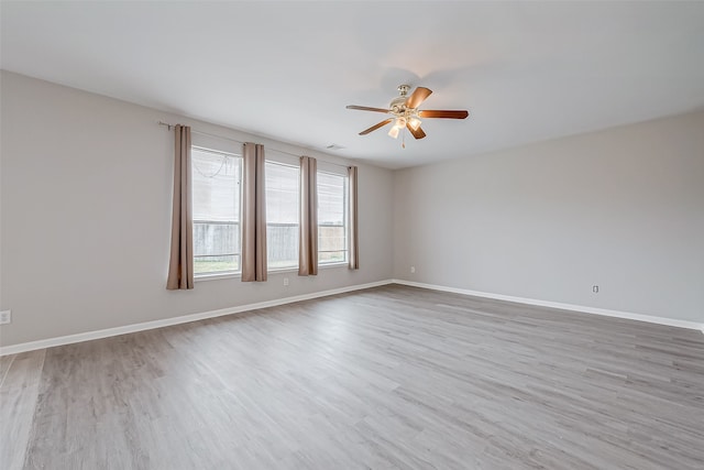 empty room with light hardwood / wood-style floors and ceiling fan