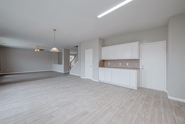 unfurnished living room featuring ceiling fan and light hardwood / wood-style floors