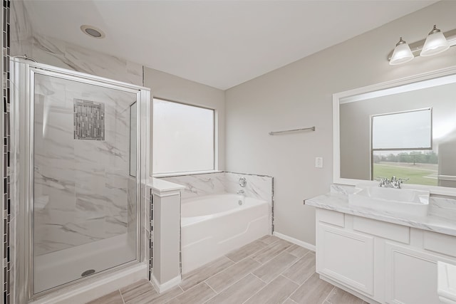 bathroom with shower with separate bathtub and vanity