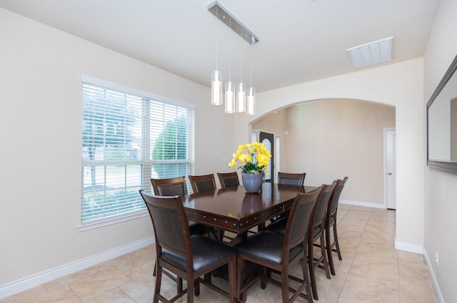 dining area with light tile patterned floors