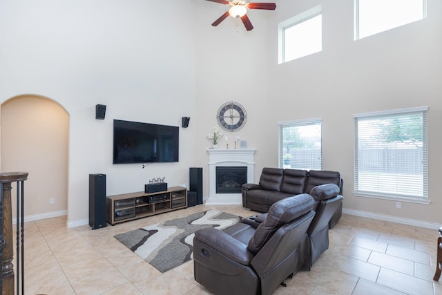 tiled living room featuring ceiling fan