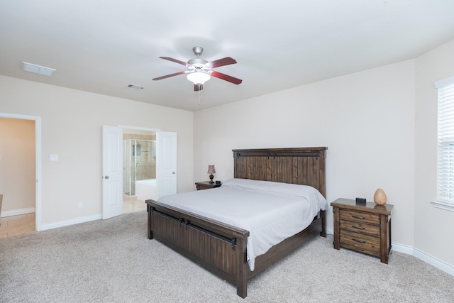 carpeted bedroom featuring ceiling fan, connected bathroom, and multiple windows