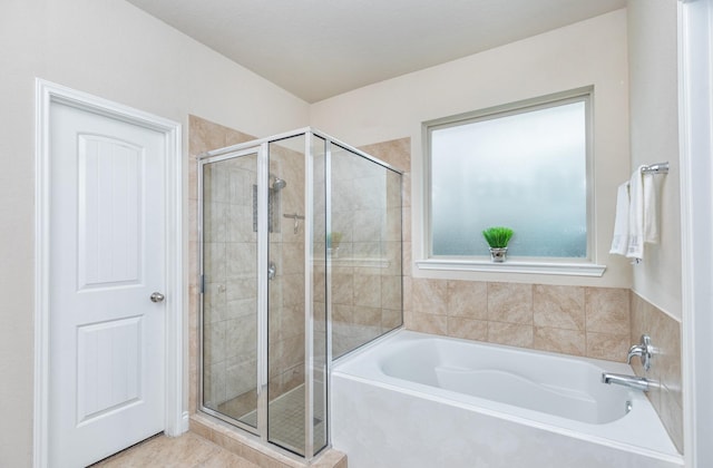 bathroom with tile patterned flooring and independent shower and bath