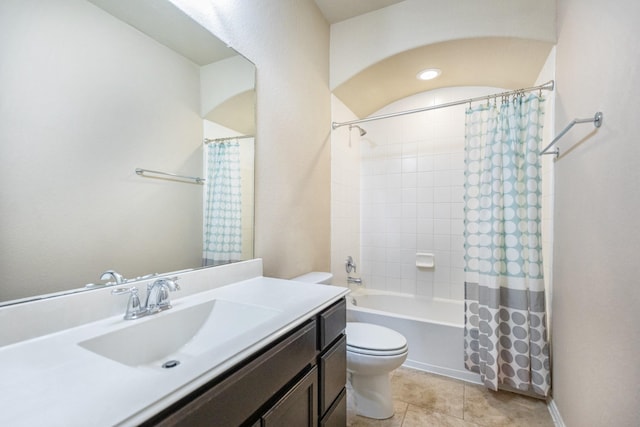 full bathroom featuring shower / tub combo with curtain, vanity, tile patterned flooring, and toilet