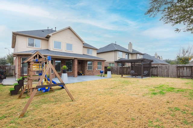 rear view of property featuring a pergola, a yard, a patio, and a playground