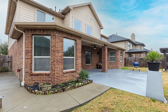 back of property with a patio