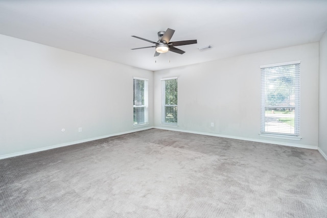 carpeted spare room featuring ceiling fan