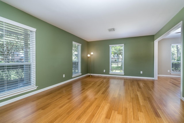 spare room with plenty of natural light and light wood-type flooring