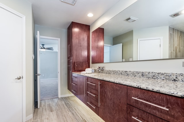 bathroom featuring vanity and ceiling fan