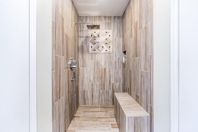 bathroom with a tile shower