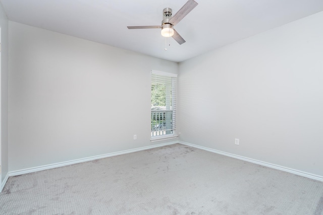 unfurnished room with light colored carpet and ceiling fan