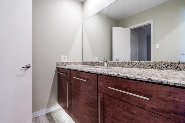 bathroom with vanity and hardwood / wood-style floors