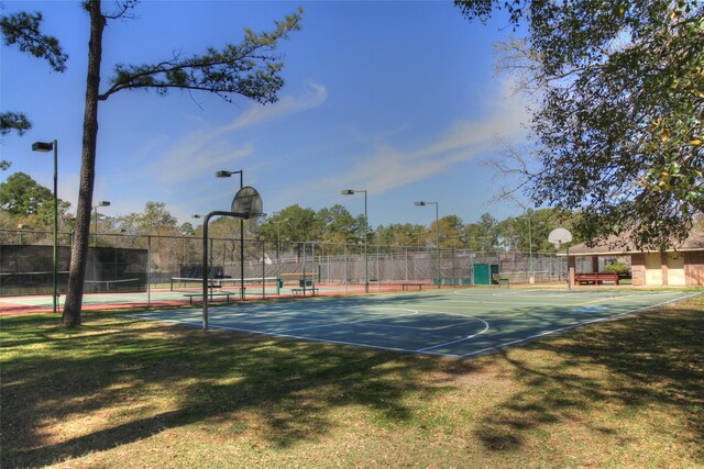 view of basketball court with a yard and tennis court