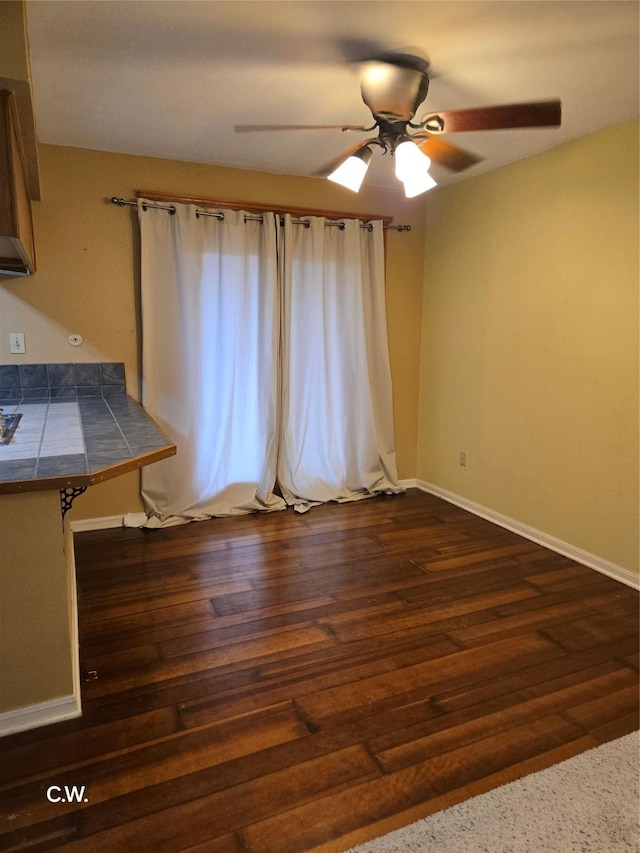 interior space featuring dark hardwood / wood-style floors and ceiling fan