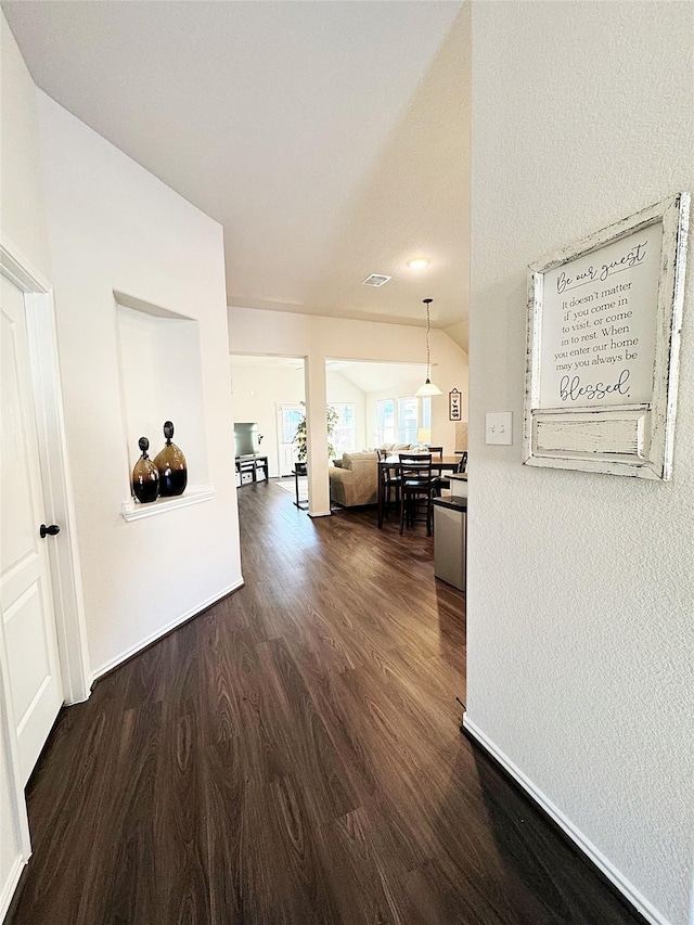 hallway with dark hardwood / wood-style floors