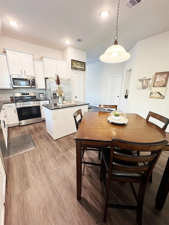 dining area with light hardwood / wood-style floors