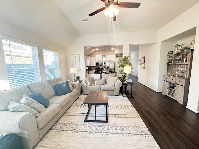 living room featuring hardwood / wood-style flooring, lofted ceiling, and ceiling fan