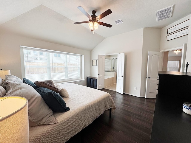 bedroom featuring lofted ceiling, ceiling fan, dark hardwood / wood-style floors, connected bathroom, and a textured ceiling