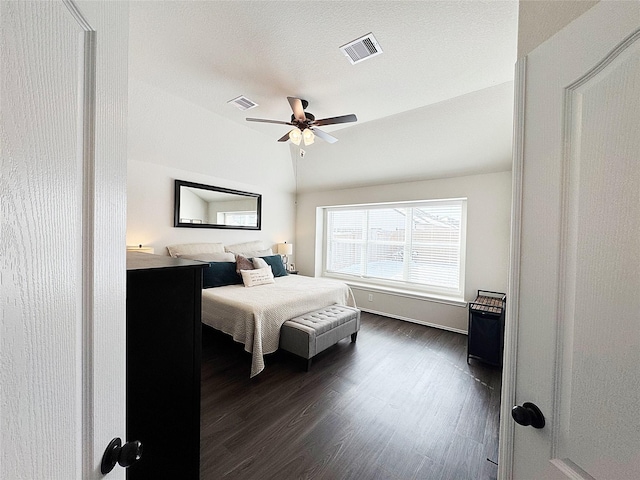 bedroom with dark wood-type flooring, ceiling fan, and vaulted ceiling