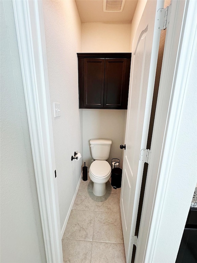 bathroom featuring tile patterned floors and toilet