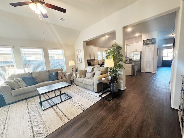 living room featuring ceiling fan, lofted ceiling, and dark hardwood / wood-style flooring